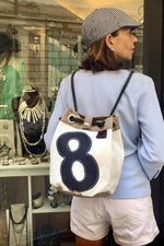Bucket bag, shoulder bag, backpack handmade from repurposed sailcloth and nautical canvas by jm sails and bags in Italy presented by model