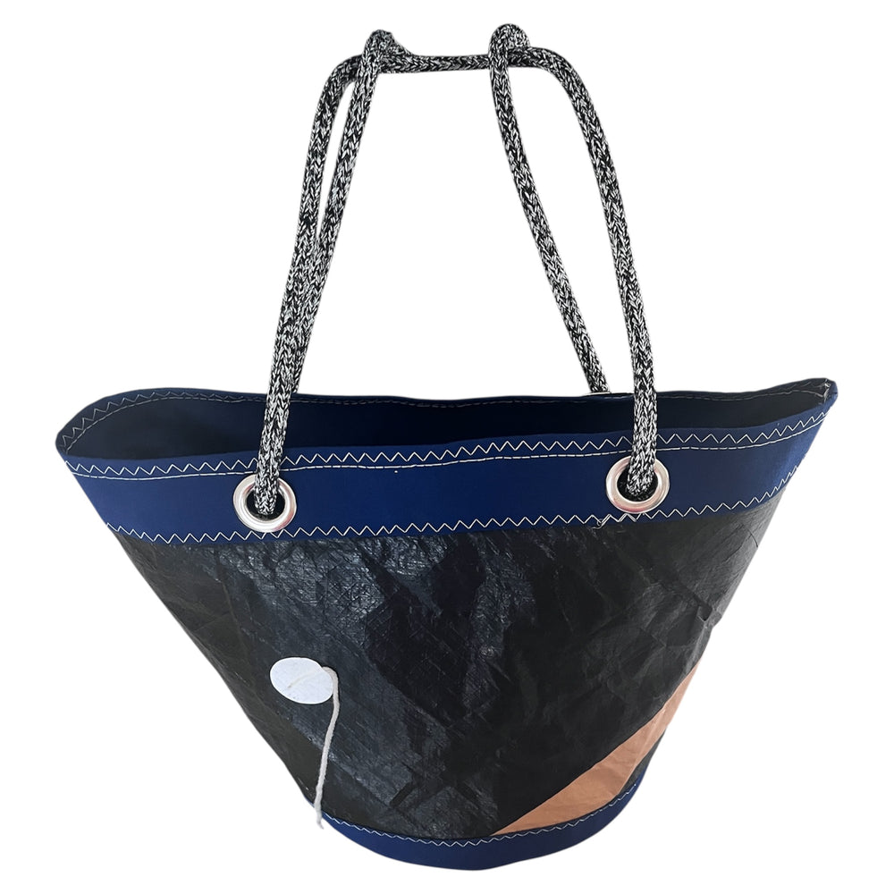 
                  
                    Black and blue shoulder bag with rope handles on a white background
                  
                