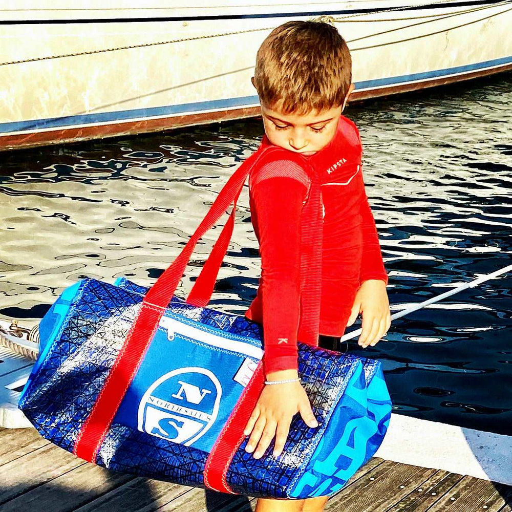 
                  
                    Duffel Bravo Medium  made from upcycled sails with young photo model J-M Sails and Bags
                  
                